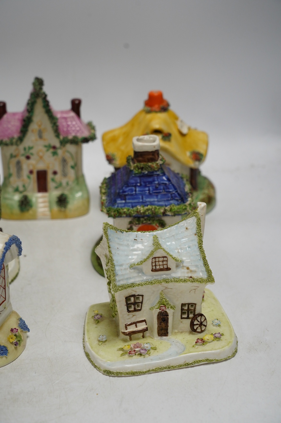 Ten various ceramic model cottages. Condition - fair to good